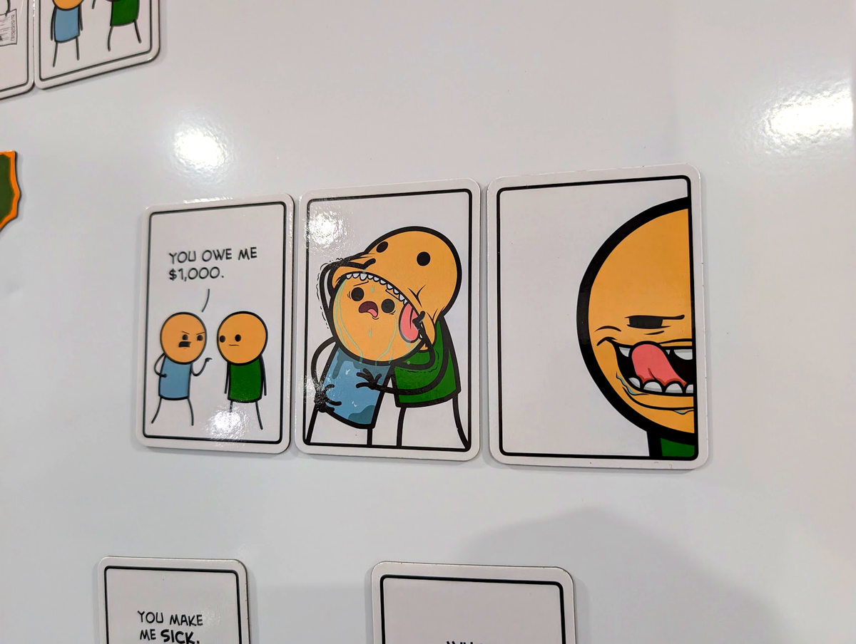 Joking Hazard fridge magnets arranged into comics on a fridge